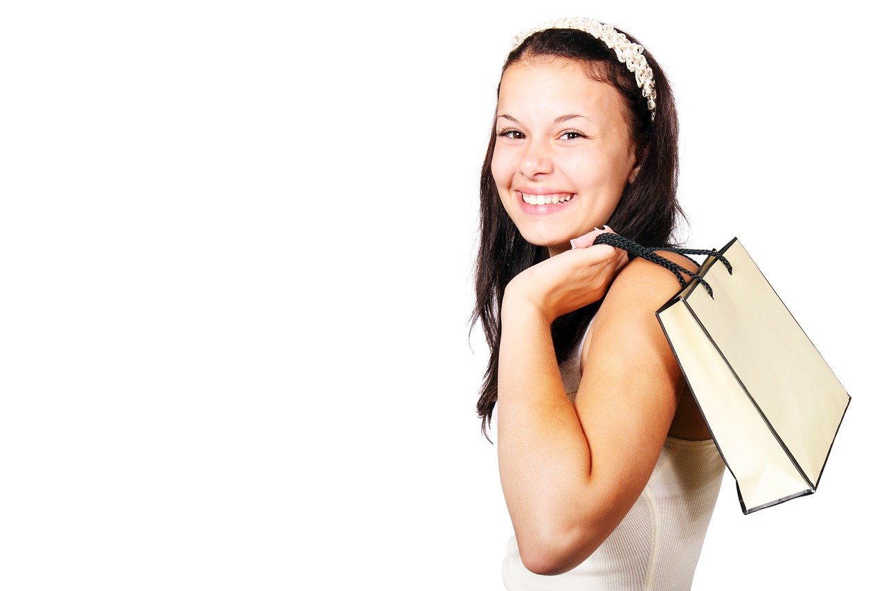 4 Tips for Encouraging Repeat Customers - a happy customer with a shopping bag slung over her shoulder