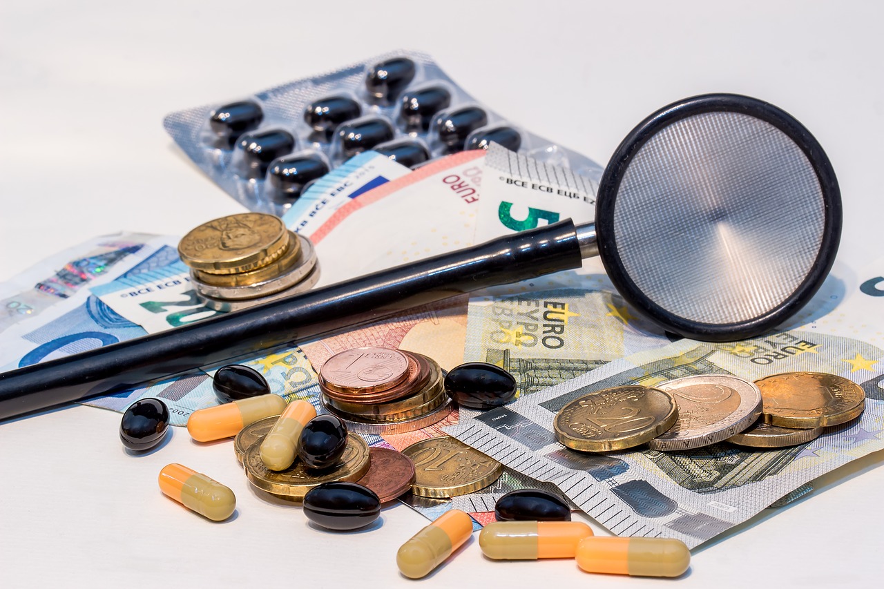 5 Ways to Recover After a Financial Setback - Notes and coins with stethoscope and medications.